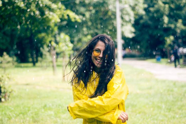 Young woman dancing in the rain